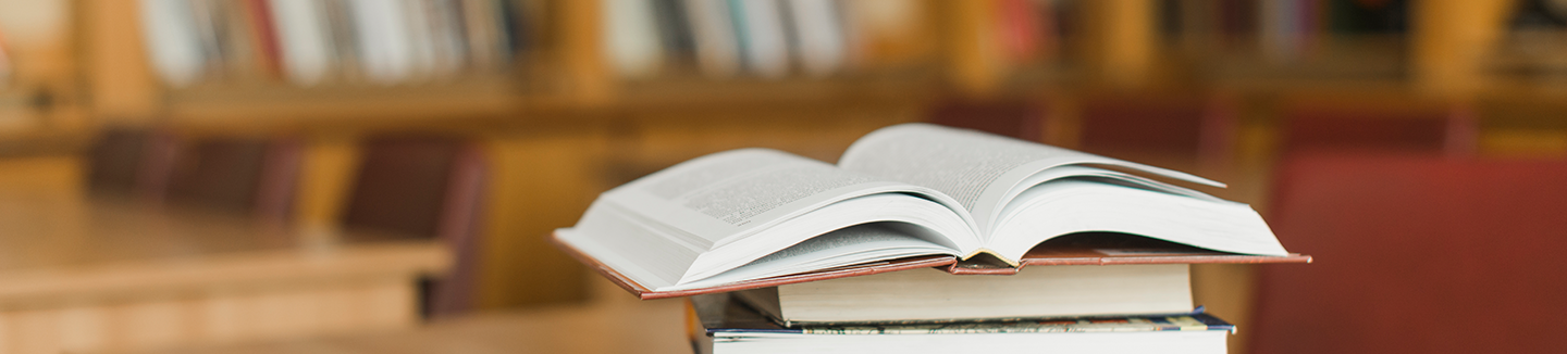 Stack of books on library desk