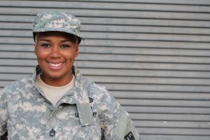 U.S. Army soldier woman of color smiling.