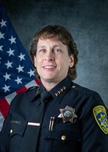 Police Chief Kelli Florman, white woman with short curly bro Police Chief Kelli Florman, white woman with short curly bro