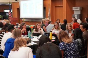 A group of educators and professionals are engaged in discus