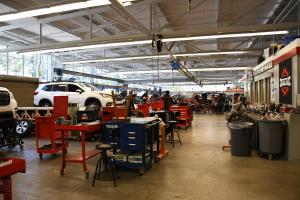 Photograph of students in the Ventura College Automotive Career Education Lab working on cars.