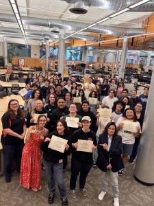 Ventura College Stan Weisel Tutoring Center staff and newly certified CRLA Level One tutors gather in the tutoring center and hold their certification documents.